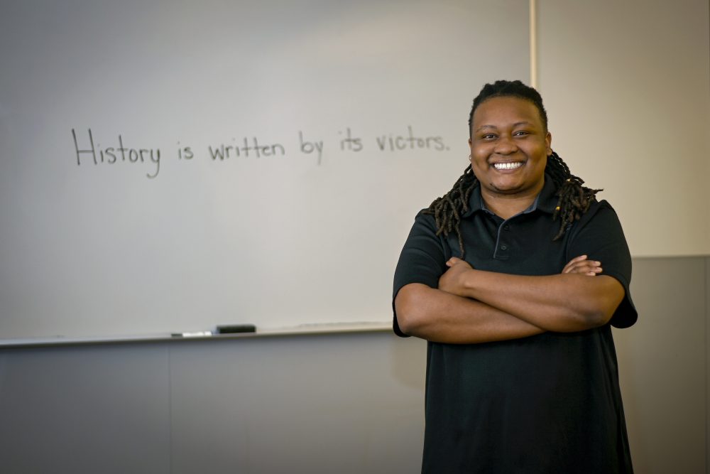 Makayla Dockery photograph with "History is written by its victors" written on the board in the background.